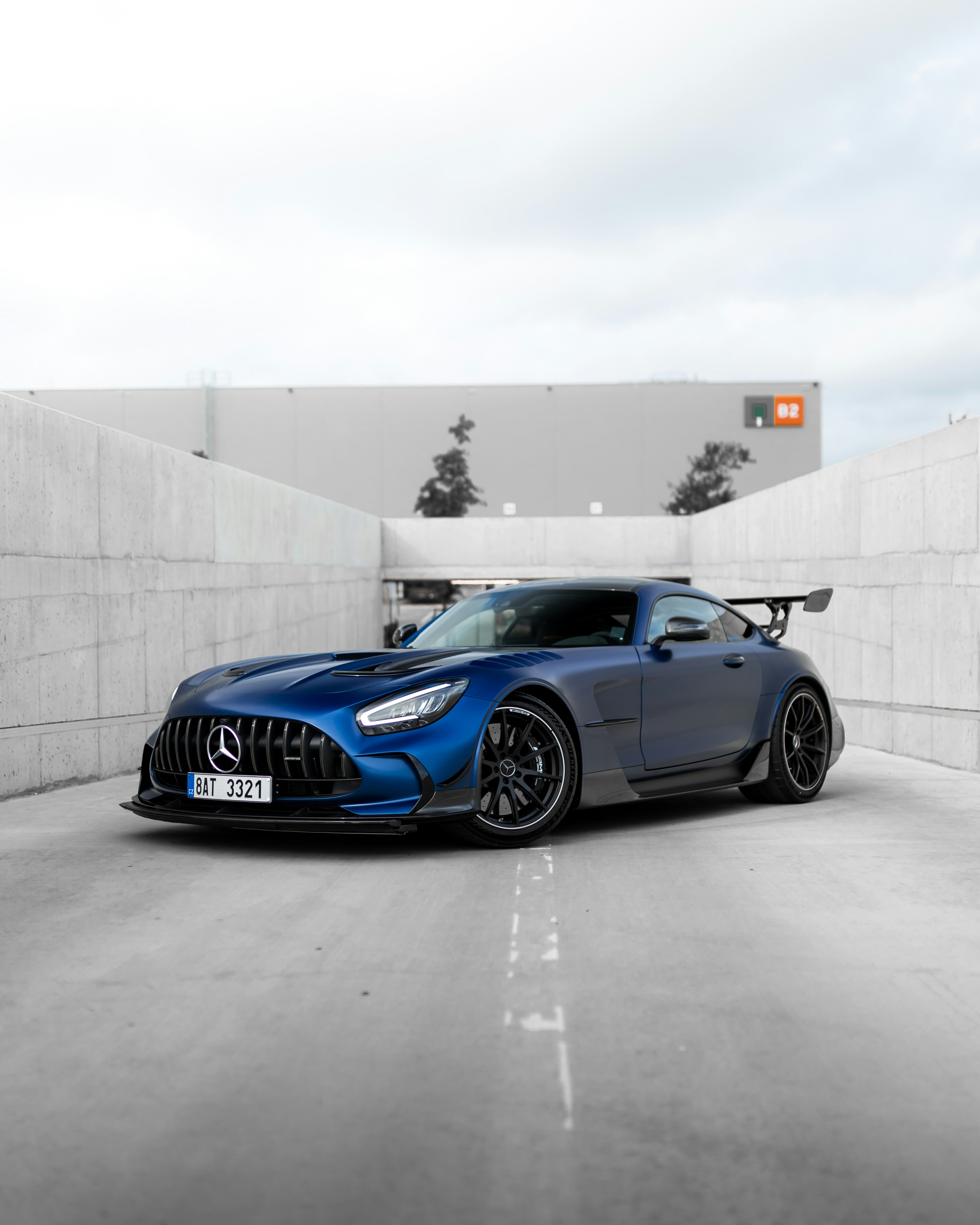 blue bmw m 3 coupe parked on gray concrete floor